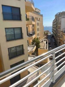 a view from the balcony of a building at Seafront Two Bedroom Apartment in St Julian's