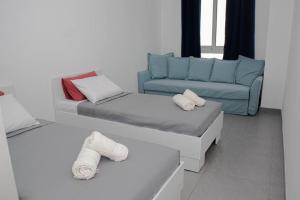 a living room with a bed and a couch at Seafront Two Bedroom Apartment in St Julian's