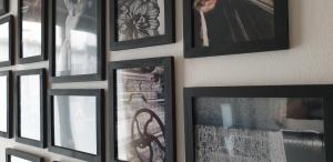 a bunch of framed pictures hanging on a wall at Maison à deux pas de l'hôtel de ville in Calais