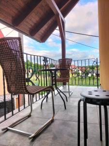 two chairs and a table on a balcony with a view at Horizont in Bulhary