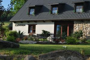 a cottage with a garden in front of it at Eskapada in Stronie Śląskie