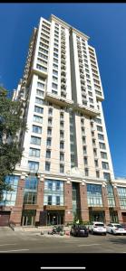 a tall building with cars parked in front of it at KADOR HOME HOTEL downtown in Kyiv