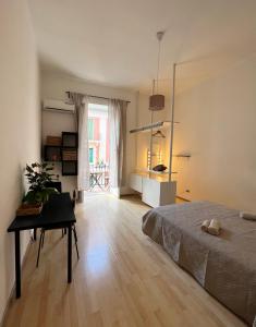 a bedroom with a bed and a table in it at Mariamora Apartment in Bari