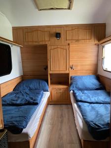 a bedroom with two beds and a tv in it at Tropikalny Zakątek in Sarbinowo