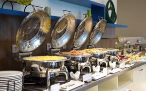 a buffet line with many plates of food at Hilton Garden Inn Ufa Riverside in Ufa