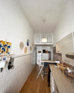 a kitchen with white walls and a counter top at Mariamora Apartment in Bari +63 photos