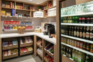 a grocery store aisle with a lot of drinks at Hilton Garden Inn Riga Old Town in Rīga