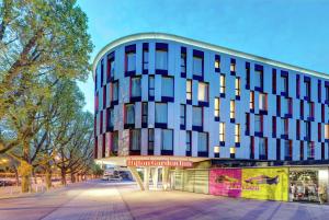 a building on a street in front of a building at Hilton Garden Inn Stuttgart NeckarPark in Stuttgart