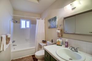 a bathroom with a sink and a toilet and a shower at Furnished Porch and Gas Grill Lakeside Cottage Stay in Pinetop-Lakeside +24 photos