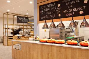 una cucina con bancone e ciotole arancioni di Hilton Garden Inn Munich Messe a Feldkirchen