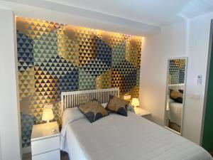 a bedroom with a bed with two pillows on it at AIRVA: Apartamentos Bajada de la Libertad in Valladolid