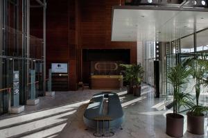 a lobby with potted plants in a building at DoubleTree by Hilton Turin Lingotto in Turin