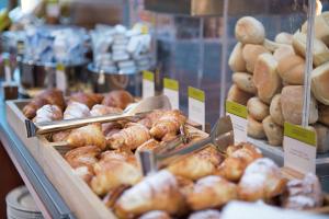 a display case in a bakery filled with lots of pastries at DoubleTree by Hilton Turin Lingotto in Turin