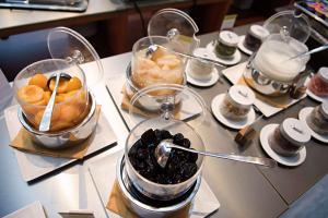 a table with some desserts in glass containers on it at DoubleTree by Hilton Turin Lingotto in Turin