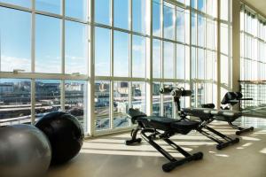 a gym with exercise equipment and a large window at DoubleTree by Hilton Turin Lingotto in Turin