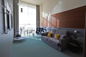 a living room with a couch and a table at DoubleTree by Hilton Turin Lingotto in Turin