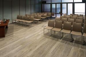 an empty conference room with chairs and tables at DoubleTree by Hilton Turin Lingotto in Turin