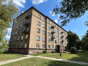 a large brick building with windows and a fire hydrant at Karaliaus apartment in Kaunas
