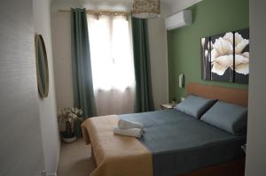 a bedroom with a blue bed and a window at Futtitinni Home casamia in Palermo