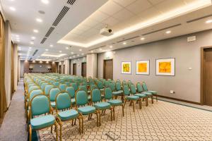 a room with a row of chairs in a hall at DoubleTree by Hilton Hotel Tyumen in Tyumen