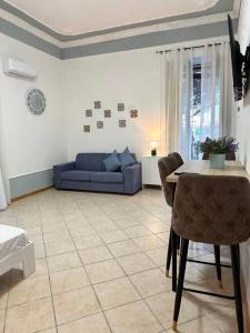 a living room with a blue couch and a table at Mediterraneo Apartment in Ercolano