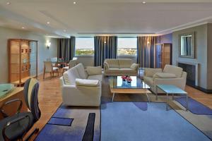 a large living room with couches and a table at Hilton Düsseldorf in Düsseldorf