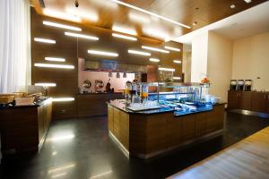 a large kitchen with a counter with drinks on it at Hilton Garden Inn Kutahya in Kütahya