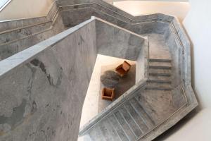 an overhead view of a staircase with a table and chairs at Hilton Garden Inn Tbilisi Chavchavadze in Tbilisi City
