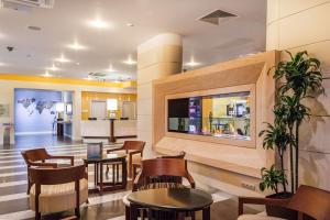 a waiting room at a hospital with tables and chairs at Hilton Garden Inn Krasnodar in Krasnodar