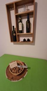 a plate of food on a table with bottles of wine at Ventanas al cerro recargado! in La Rioja