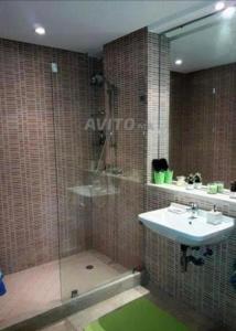 a bathroom with a shower and a sink and a shower at Appartement meublé à louer in Settat