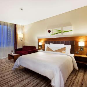 a large white bed in a hotel room at Hilton Garden Inn Konya in Konya