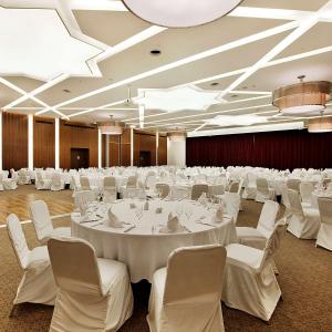 a large banquet hall with white tables and chairs at Hilton Garden Inn Konya in Konya