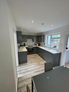 uma grande cozinha com uma mesa e um balcão em 3 bedroom house Maidstone em Maidstone