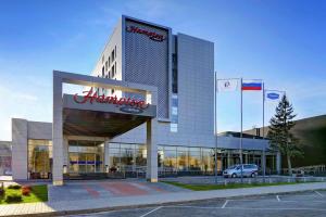 a building with a car parked in front of it at Hampton by Hilton Volgograd Profsoyuznaya in Volgograd