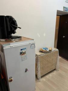 una cucina con un piccolo frigorifero e un tavolo di Monolocale al centro di Napoli A' fenestrella a Napoli