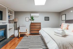 a bedroom with a large bed and a fireplace at North Central Loft in Staunton