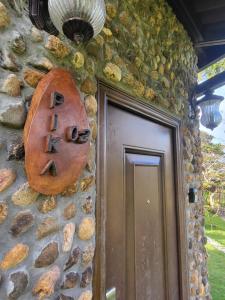 a stone building with a door with a sign on it at PIKA CABINS 2 in San Carlos