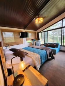 a bedroom with a bed and a desk with a lamp at PIKA CABINS 2 in San Carlos