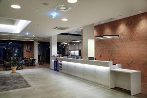 an office lobby with a desk and a counter at Hampton By Hilton Gdansk Old Town in Gdańsk