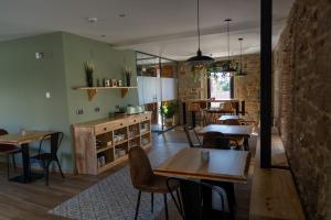 a dining room with tables and chairs and a kitchen at LA ALCOBA DE SAYAGO in Bermillo de Sayago