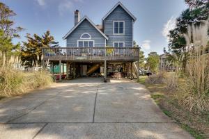 a large house with a large deck on a driveway at Hot Tub, Pirate Fort and Fire Pit Outer Banks Home! in Nags Head