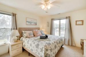 a bedroom with a bed and a ceiling fan at Hot Tub, Pirate Fort and Fire Pit Outer Banks Home! in Nags Head