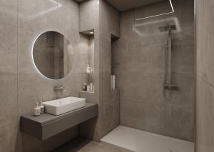 a bathroom with a sink and a shower with a mirror at La Pergola Suites in Dossobuono