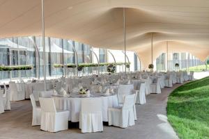 a large tent with white tables and chairs in it at DoubleTree by Hilton Moscow – Marina in Moscow