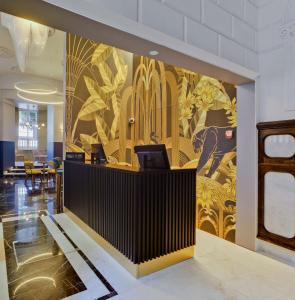 a lobby with a wall with a mural of flowers at Casa Alberola Alicante, Curio Collection By Hilton in Alicante