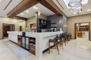 a bar in a restaurant with chairs and a counter at Hampton by Hilton Istanbul Atakoy in Istanbul