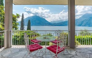 a table and chairs on a balcony with a view of the water at Varenna Wonders, Villa with pool for 14 guests in Perledo