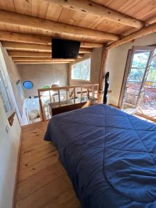 a bedroom with a blue bed in a house at Casa corazon in San Marcos Sierras