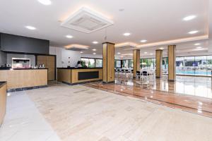 a large room with a lobby with a kitchen and a bar at Lara World Hotel in Antalya